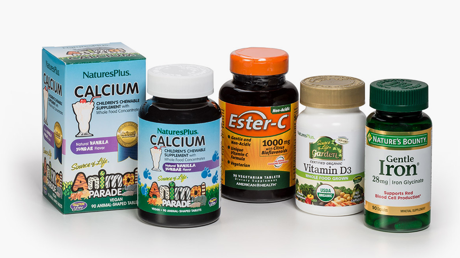 Group of vitamins including NaturesPlus Calcium, Ester-C Vegetarian Tablets, NaturesPlus Vitamin D3 and Nature's Bounty Iron Capsules